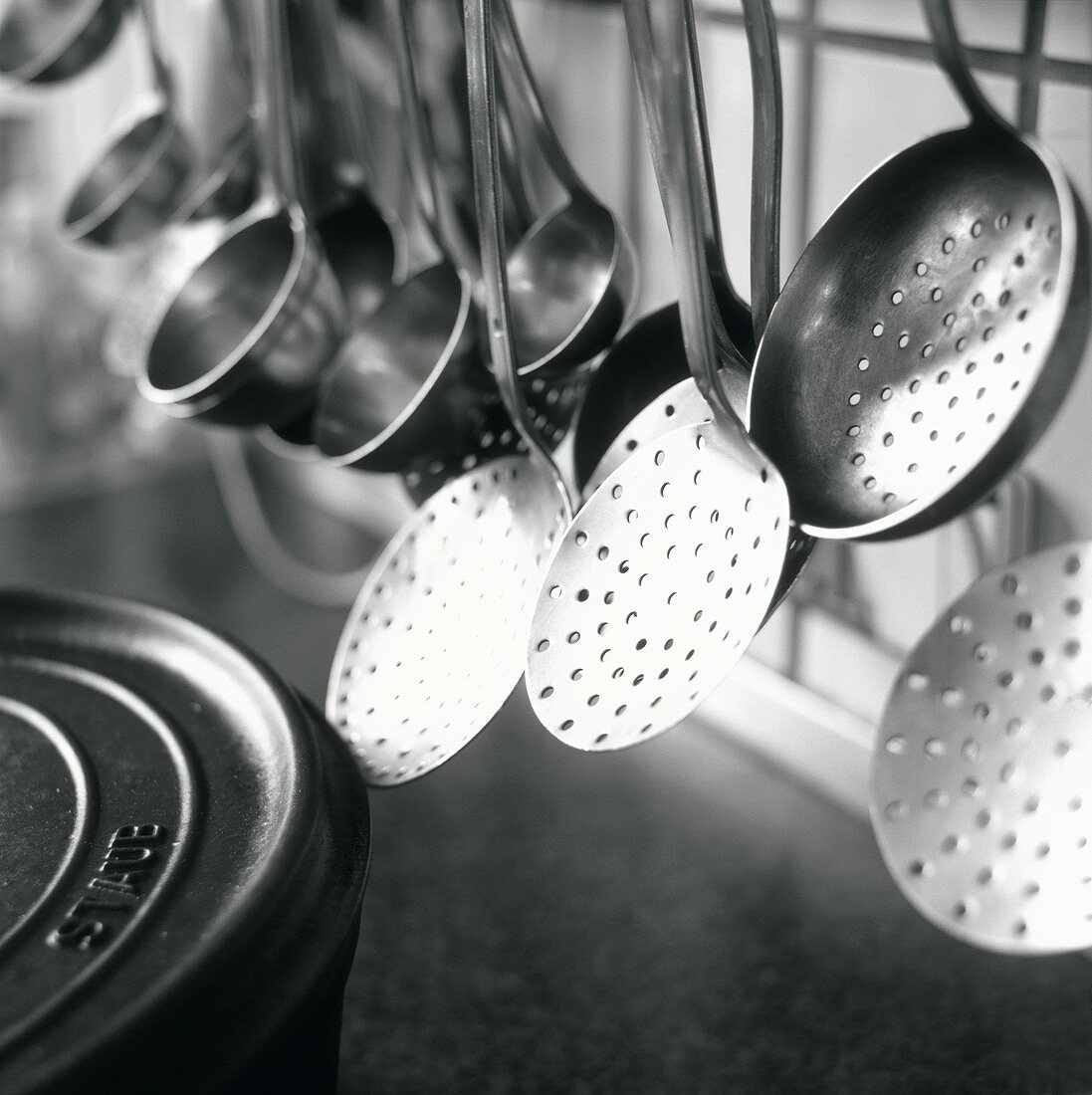 Ladles and skimmers hanging on a rack