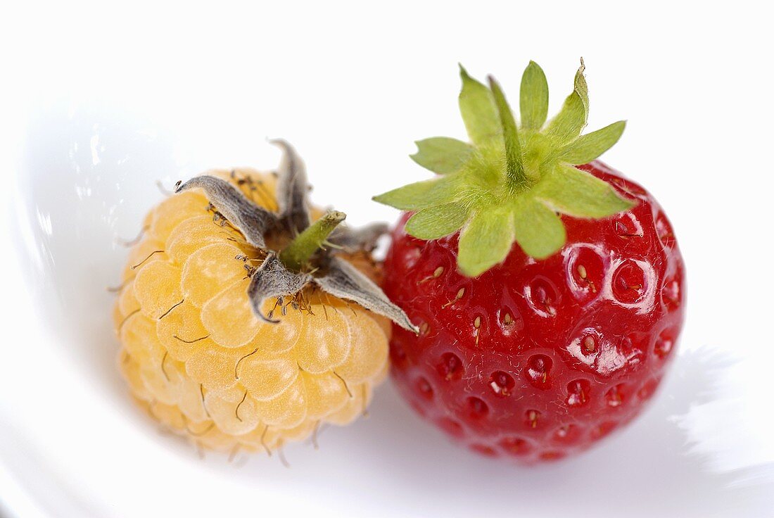 A strawberry and a white raspberry