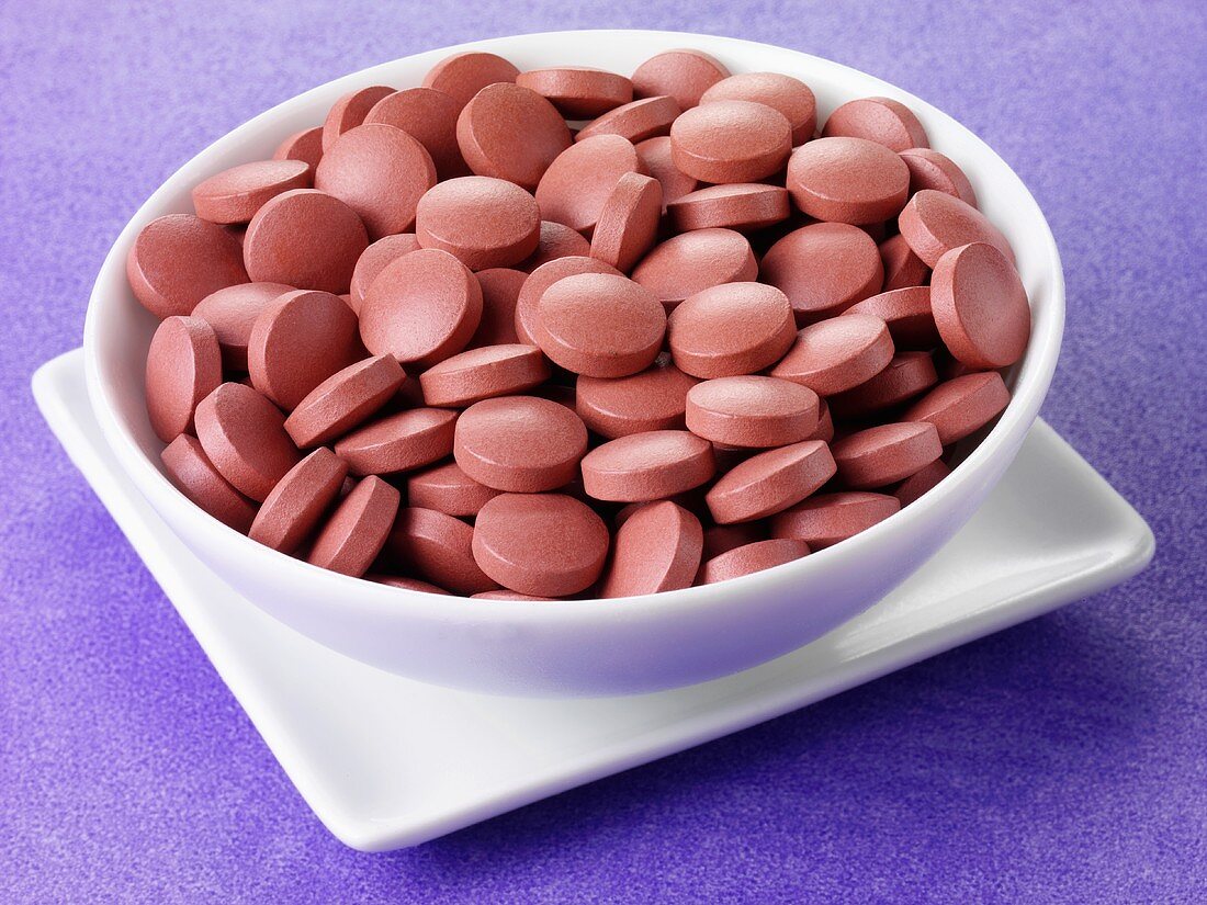 Vitamin tablets in a small bowl