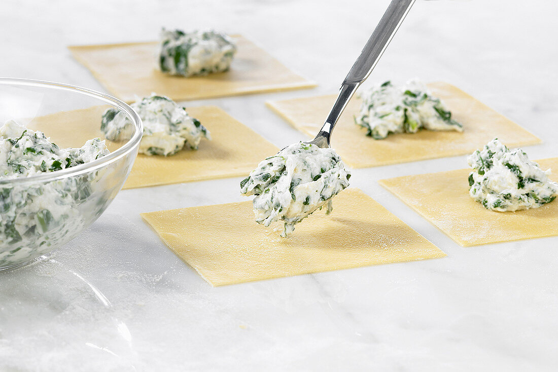Making tortellini with spinach and ricotta filling