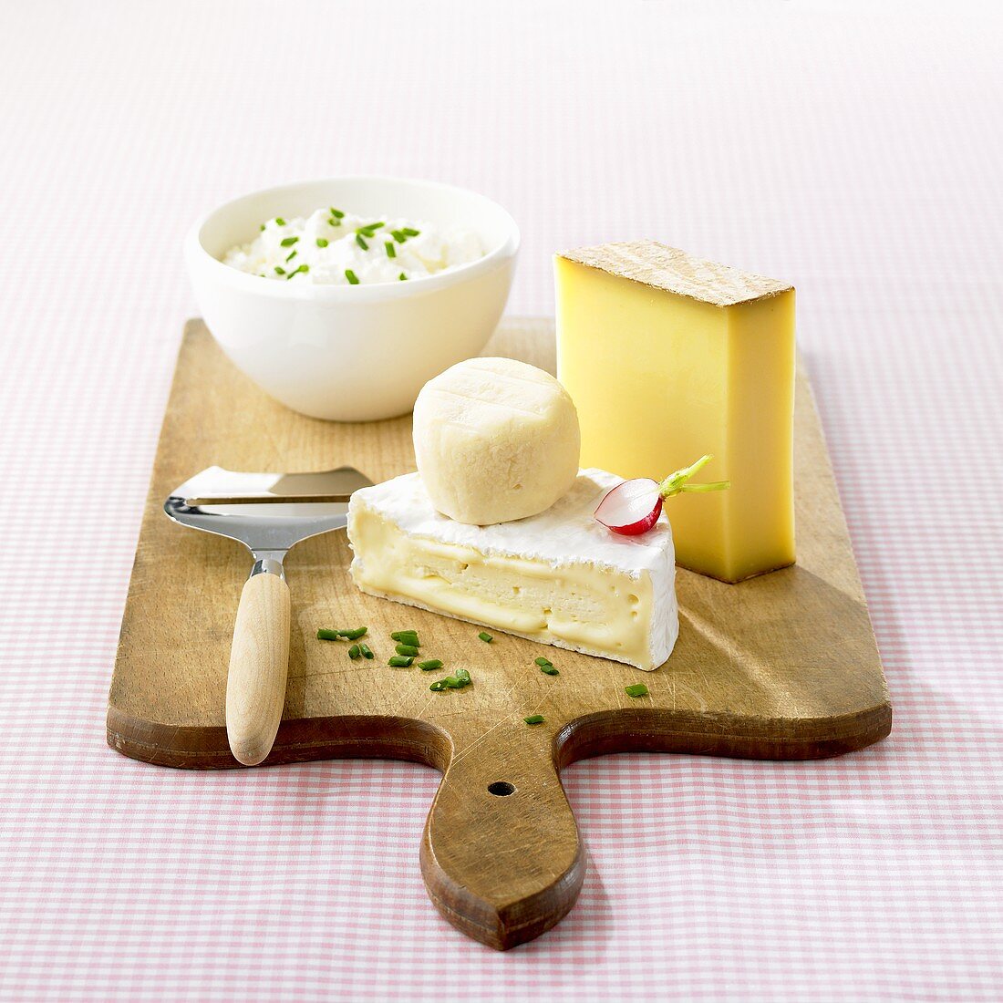 Hard cheese, soft cheese & fresh cheese on a wooden board