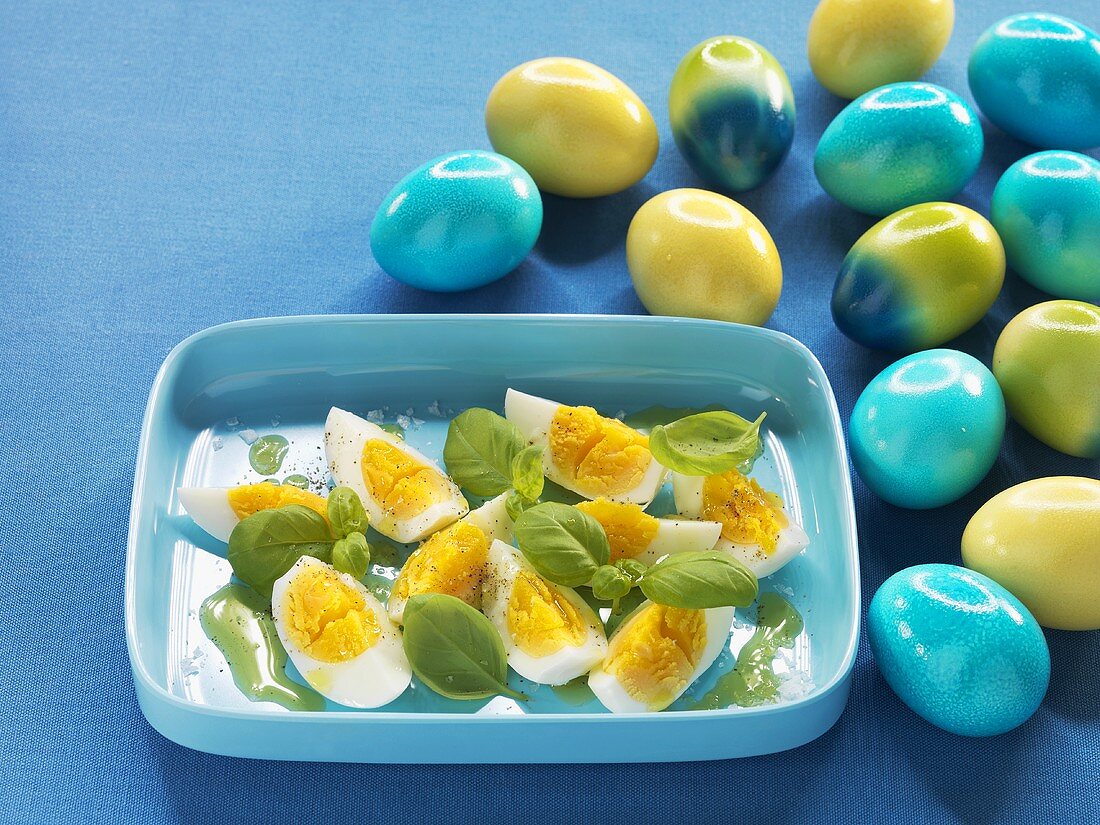 Hard-boiled eggs with olive oil and basil
