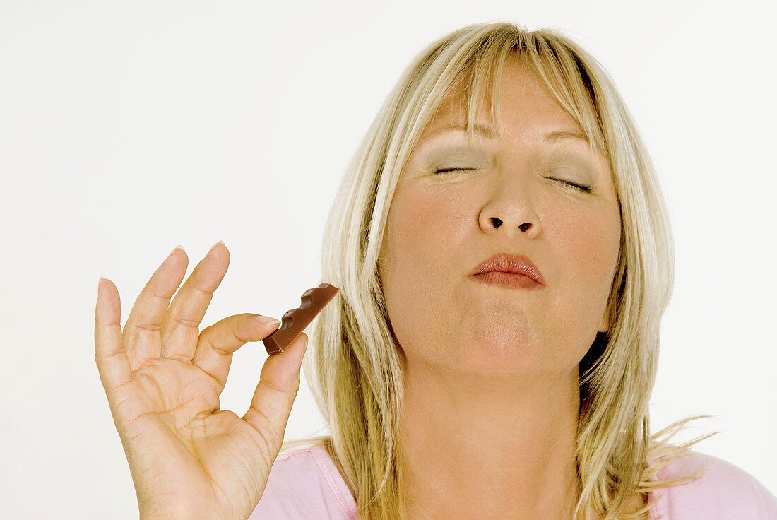 Woman enjoying a chocolate bar