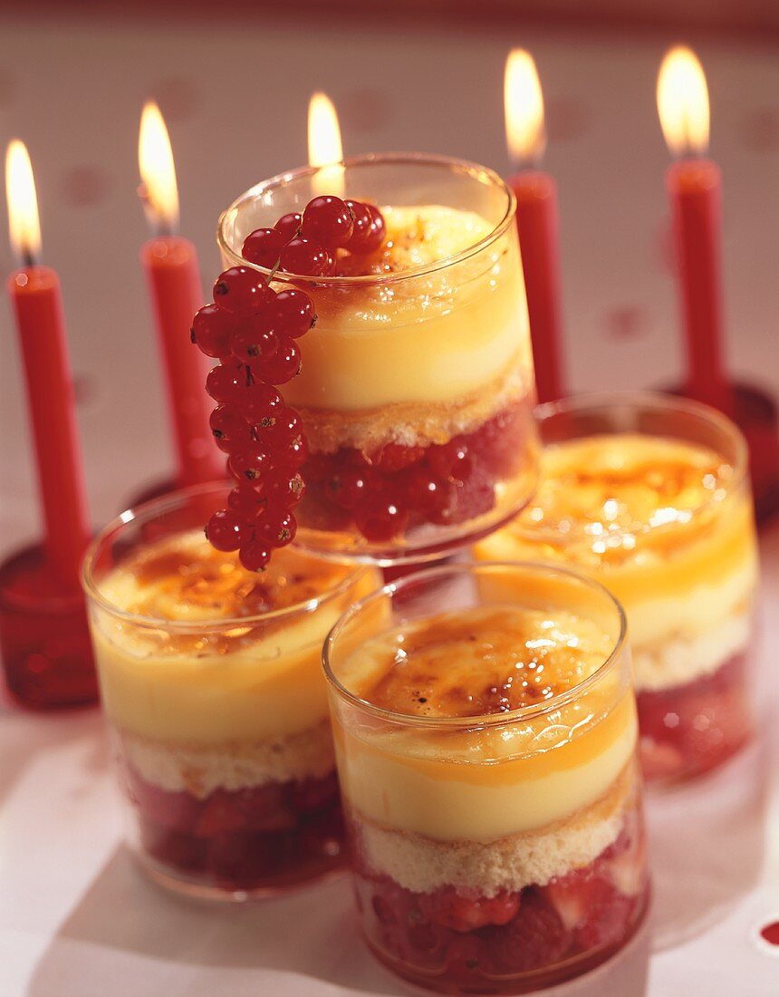 Layered dessert: berries, sponge and custard in glasses