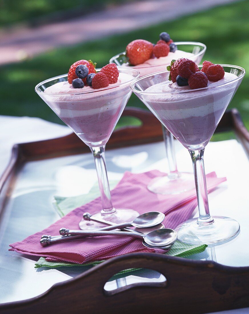 Three glasses of raspberry cream on a tray