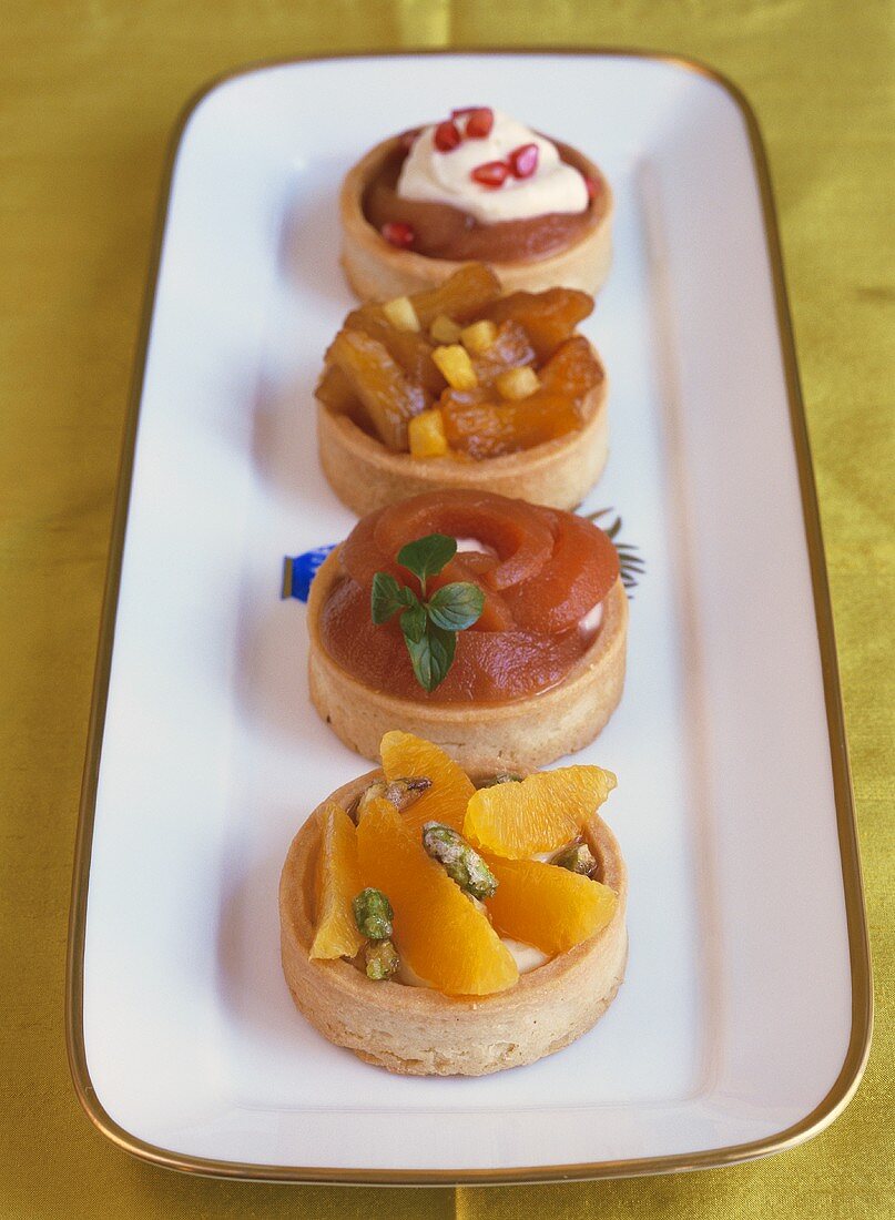 Four fruit tartlets on a platter