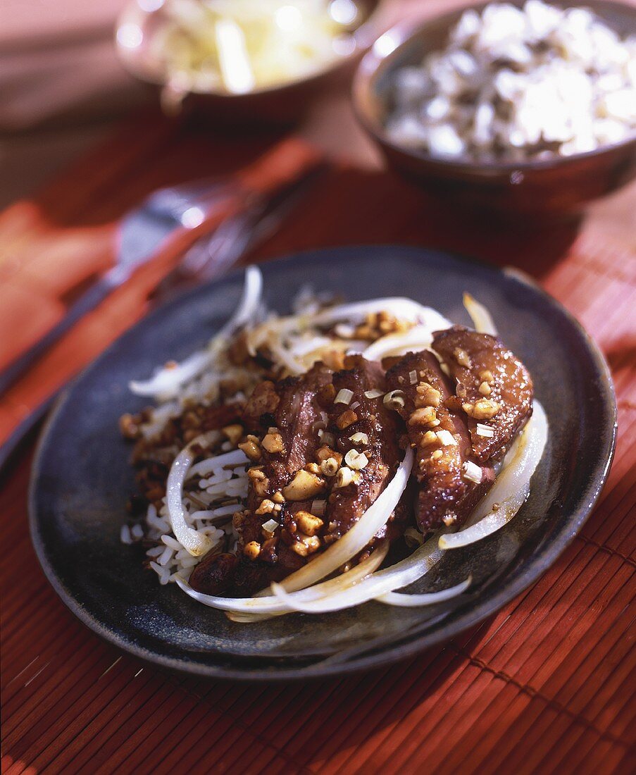 Roast duck breast with peanuts and rice
