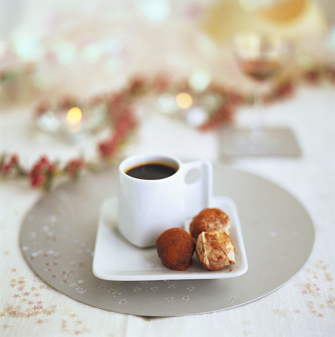 A cup of coffee and chocolate truffles
