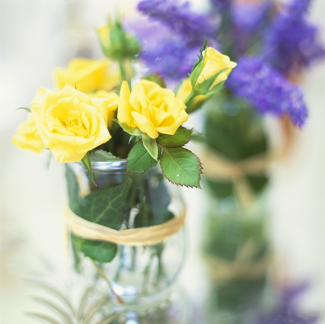 Posies of yellow roses and grape hyacinths
