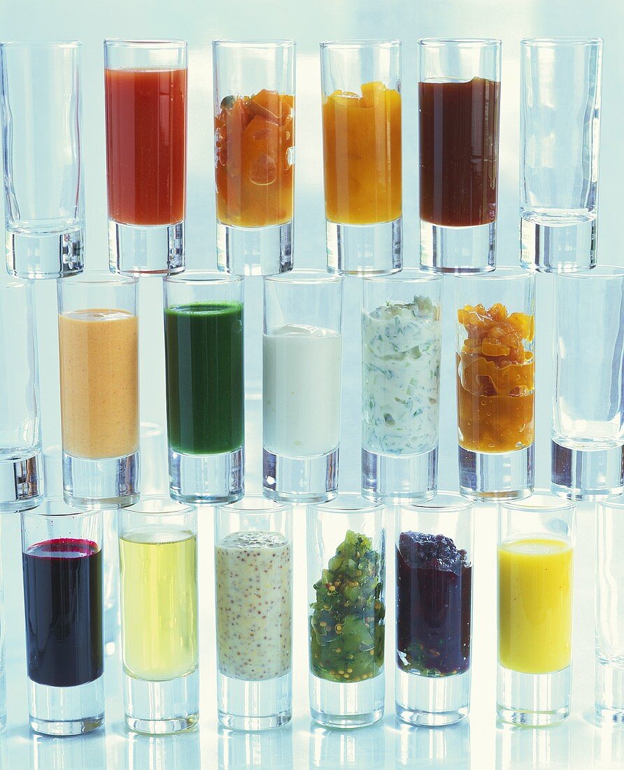 Wall of glasses containing different small appetisers