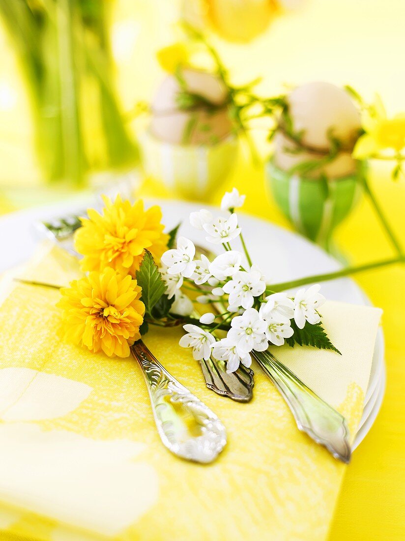 Easter place-setting with flowers and boiled eggs
