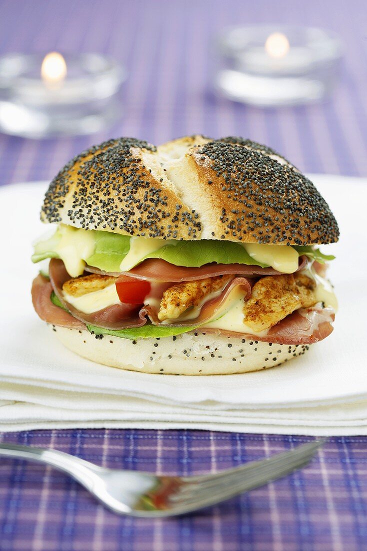 Poppy seed roll filled with tomato, chicken breast, bacon & mayo