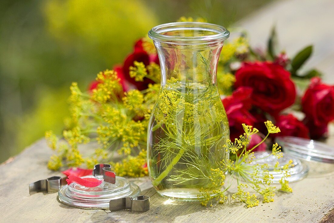 Dill vinegar in jar with roses in background