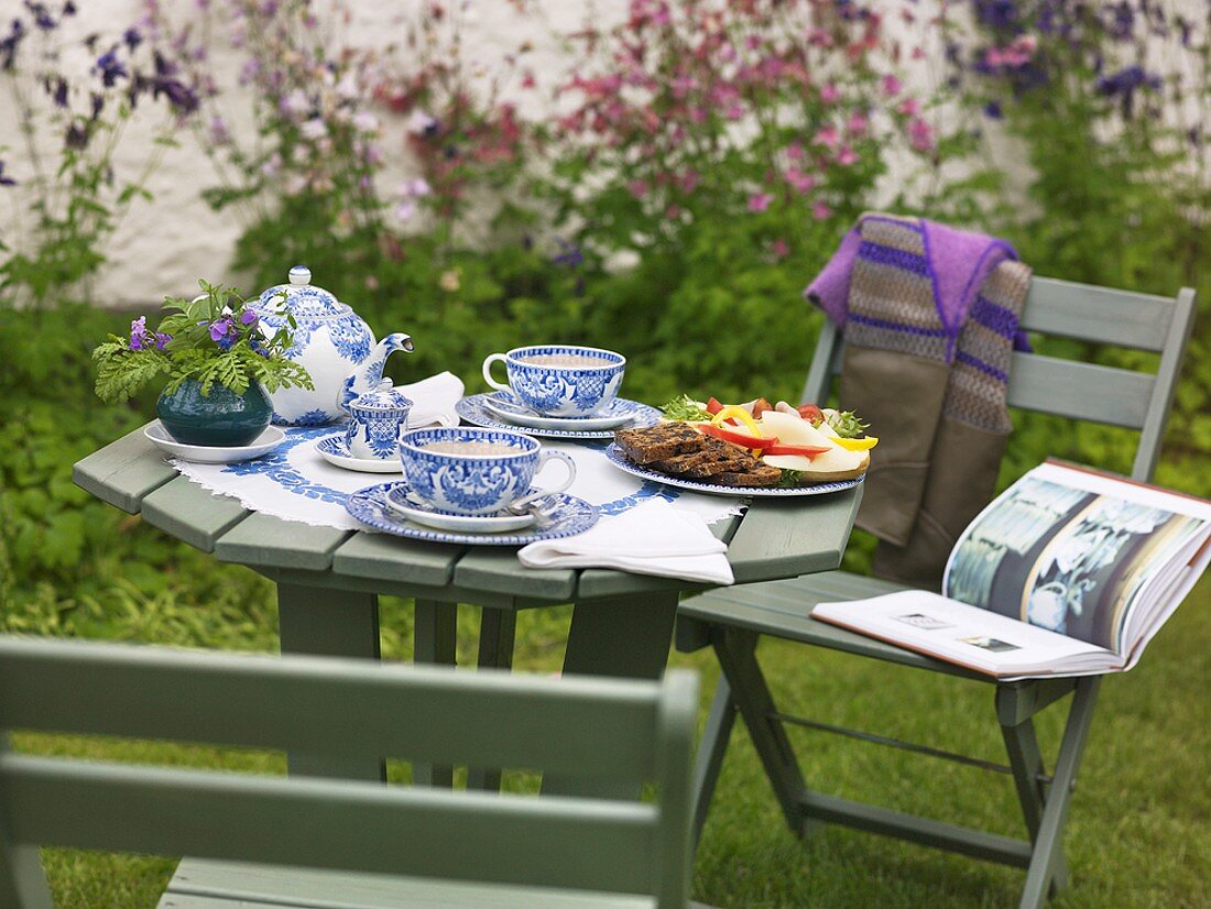 Table laid for afternoon tea in garden