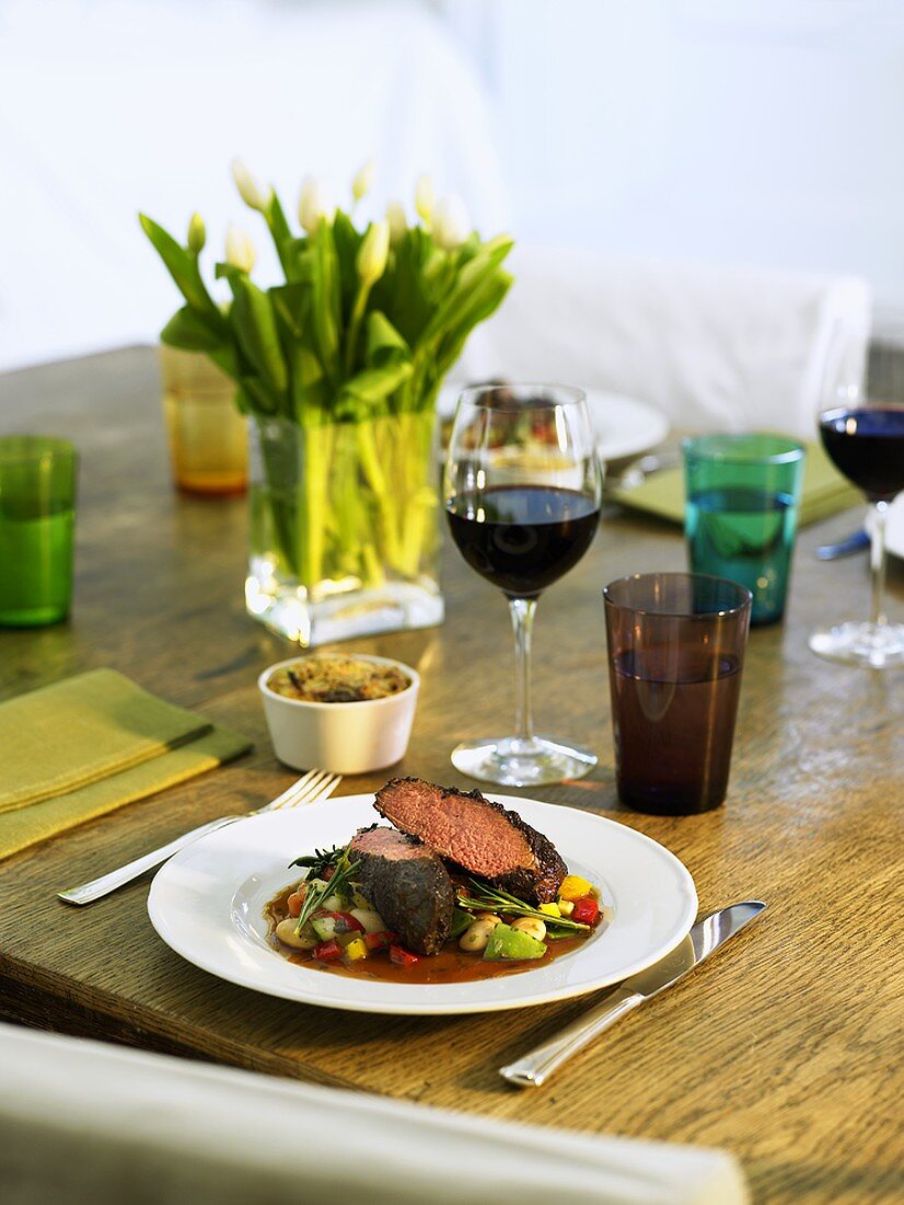Lamb fillet on bean salad with potato and courgette gratin
