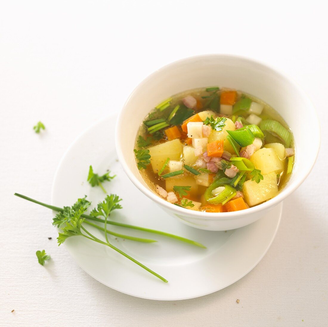 Potato and vegetable soup with diced bacon