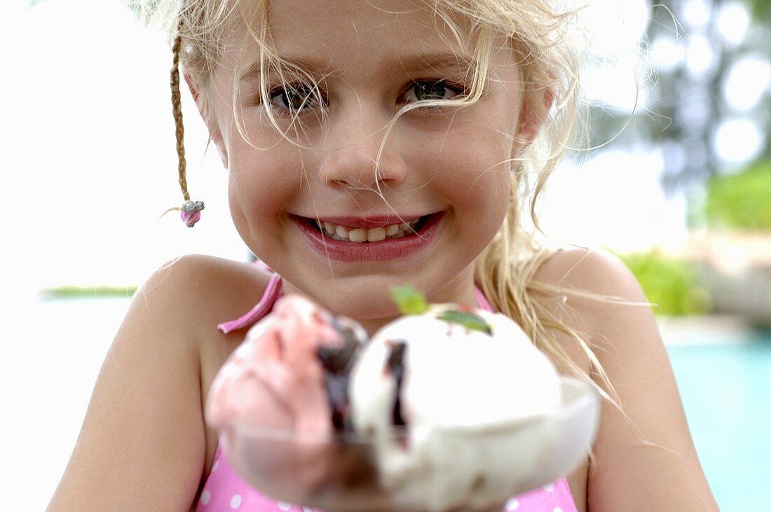 Blond girl behind a mixed ice cream sundae