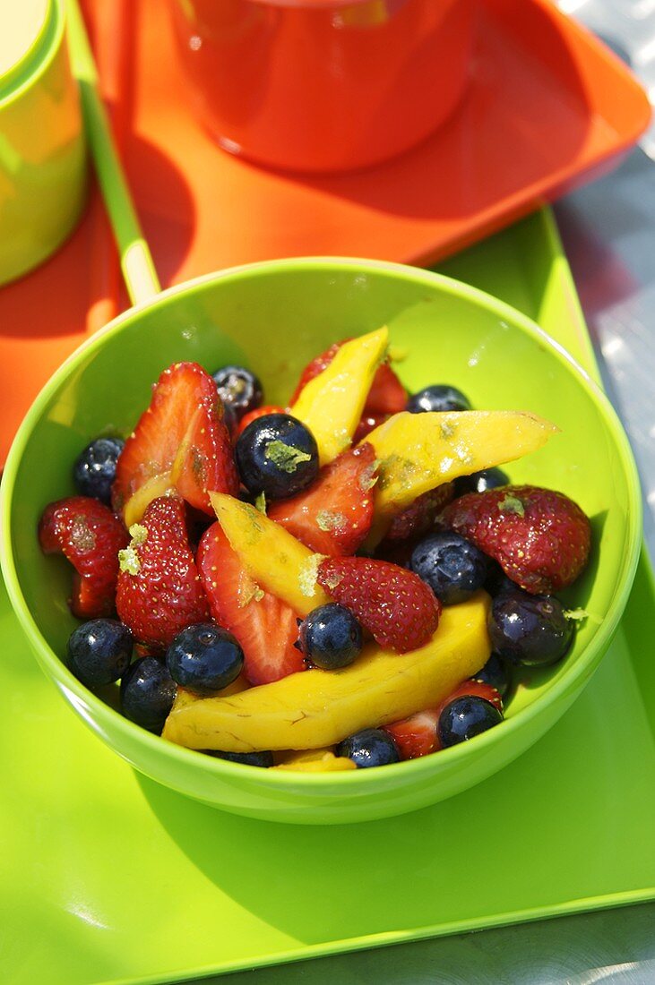 Fruchtsalat mit Mango, Erdbeeren und Heidelbeeren