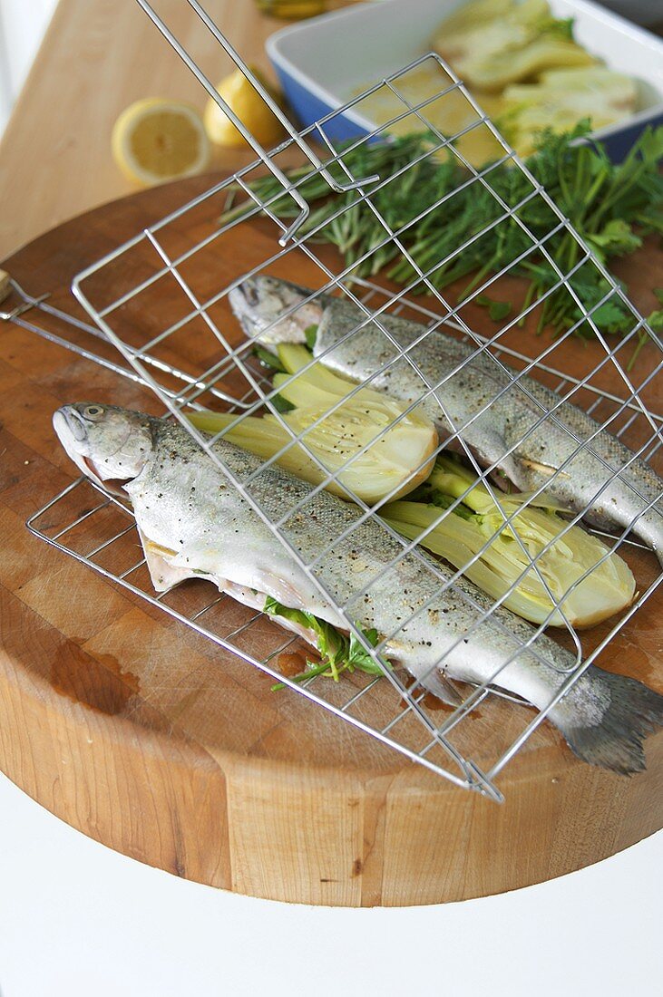 Preparing trout stuffed with herbs for grilling