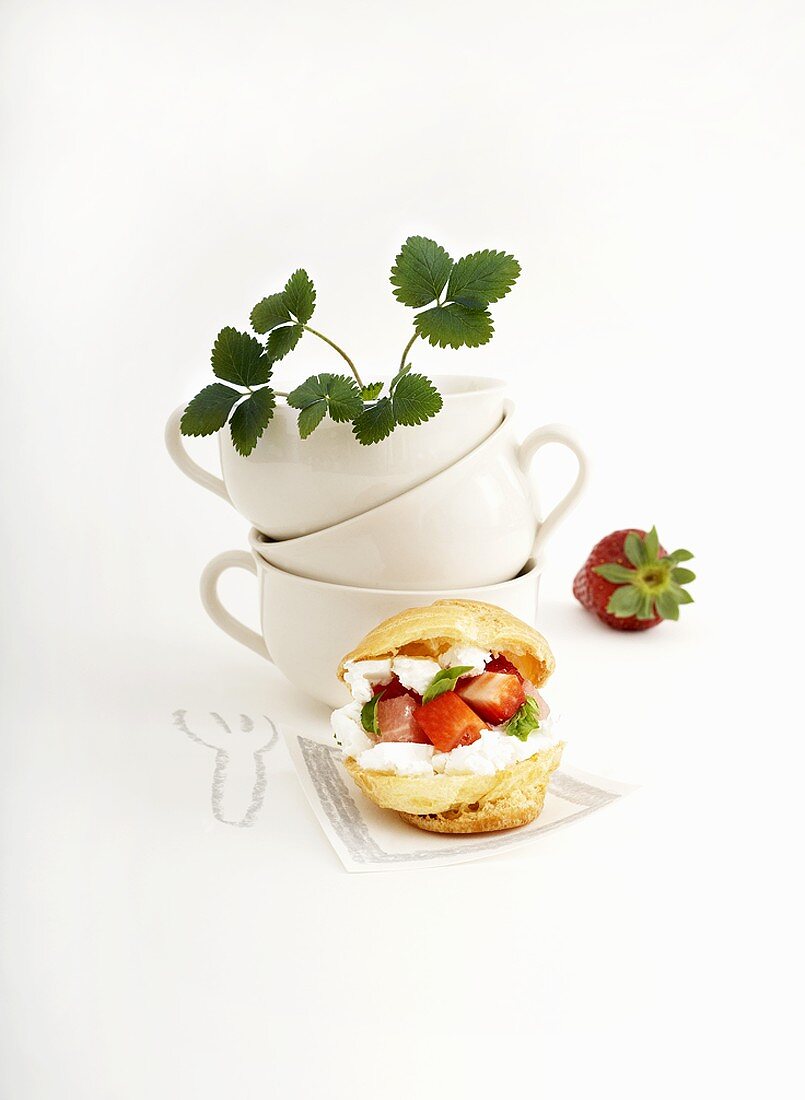 Profiterole filled with strawberries and cream