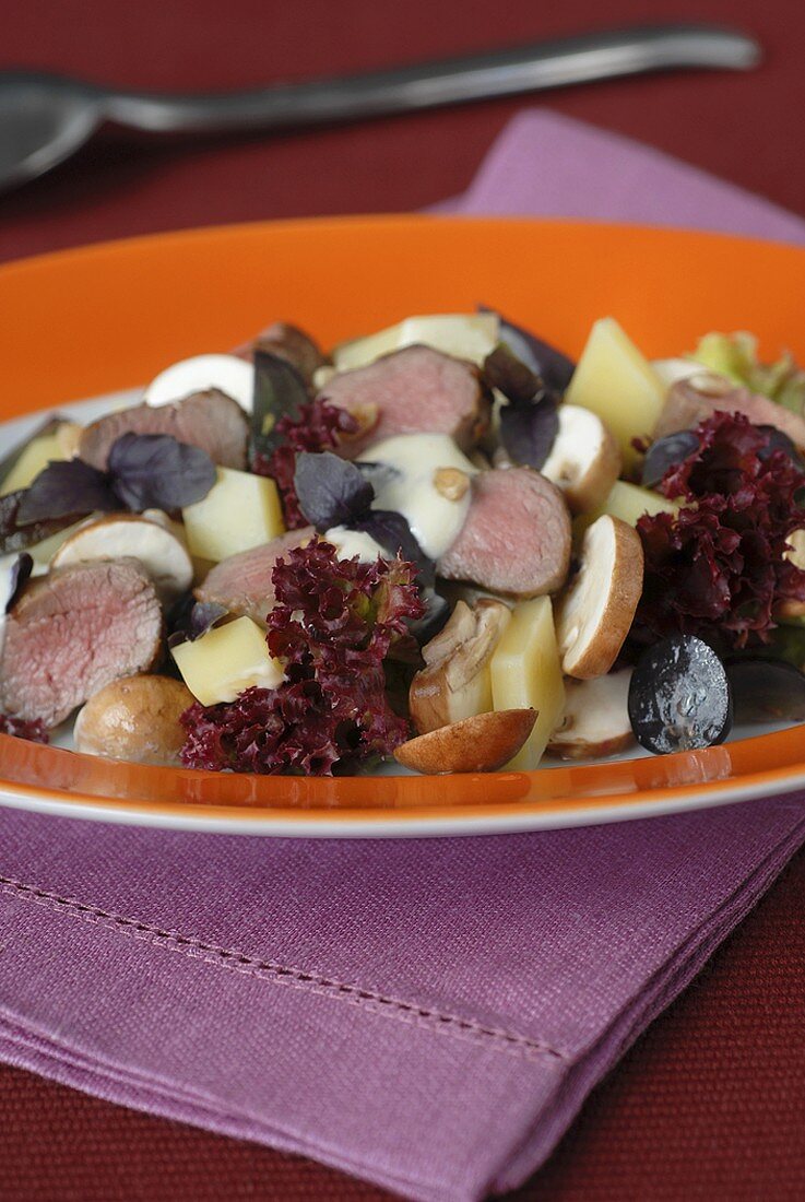 Cheese and grape salad with lamb fillet