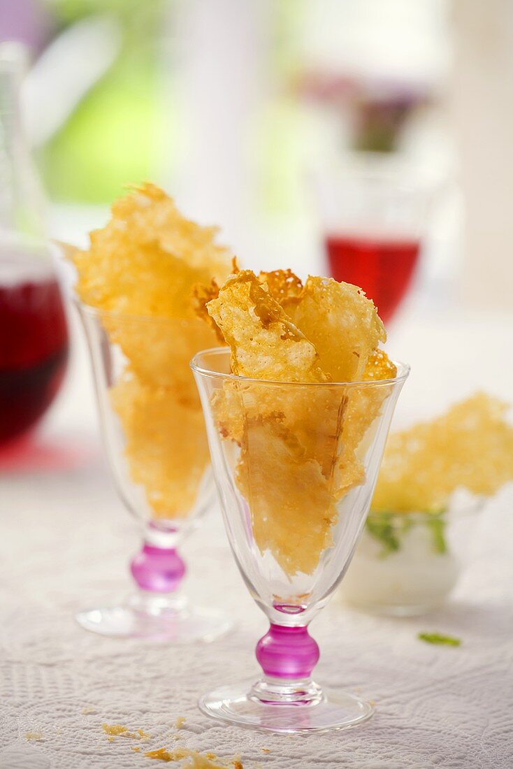 Two glasses filled with Parmesan crisps
