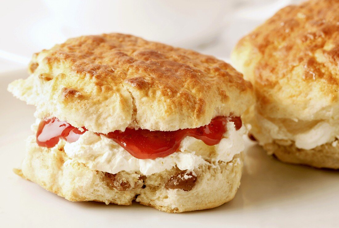 Raisin scones with cream and strawberry jam