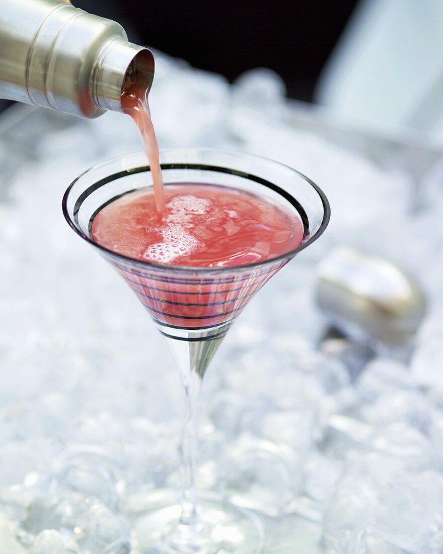 Pouring a cranberry cocktail