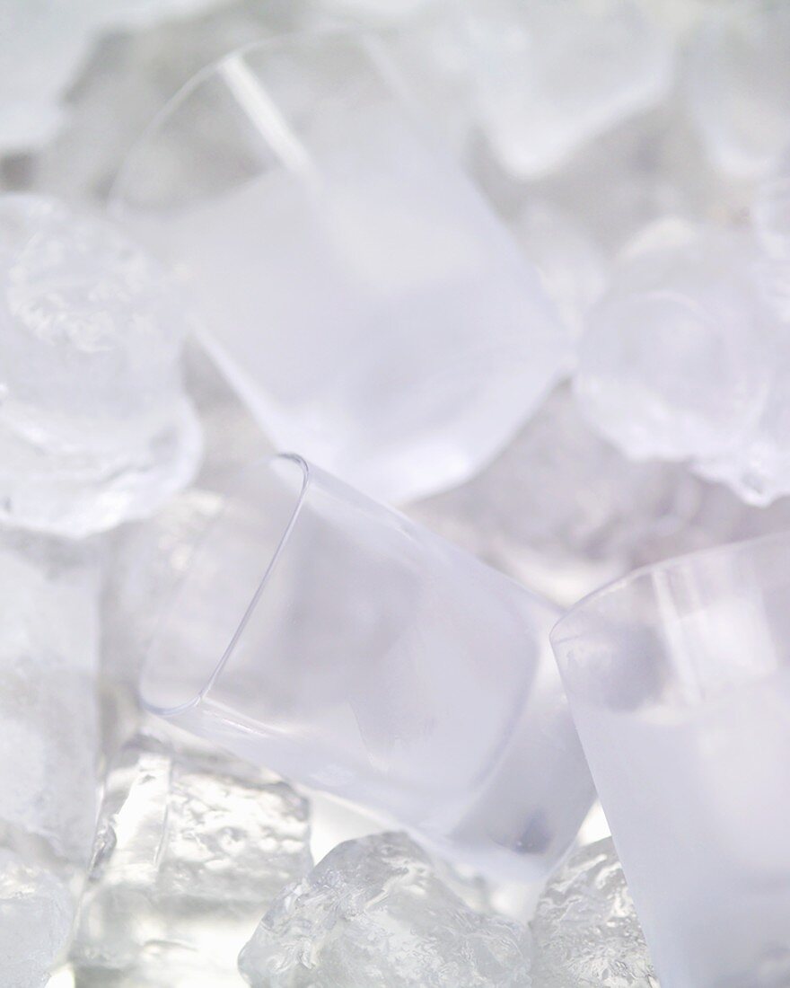 Vodka glasses among ice cubes