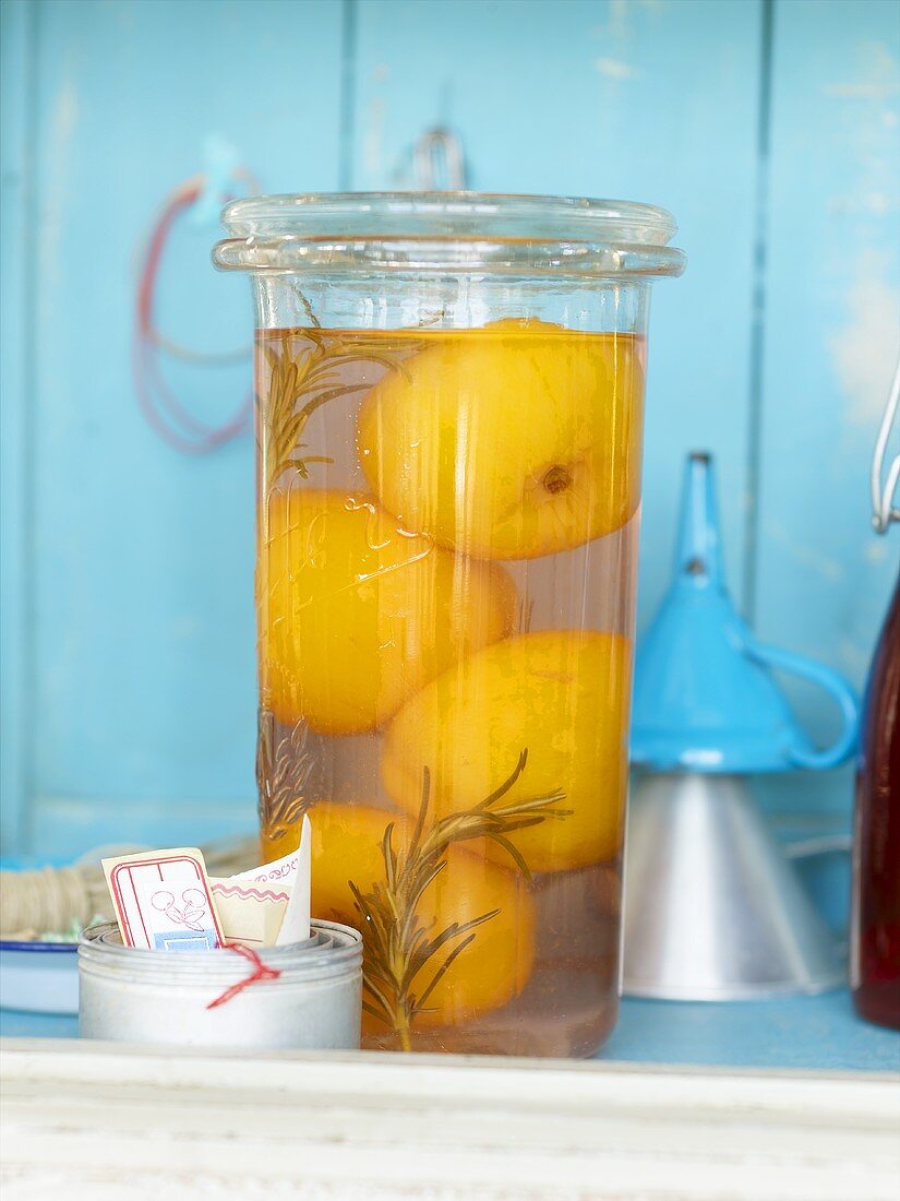 Peach compote with rosemary in a preserving jar