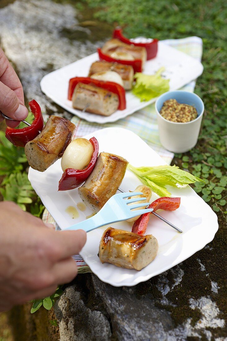 Grilled sausage kebabs with pepper and onion