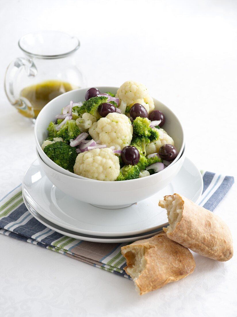 Cauliflower and broccoli salad with onions, olives and a dill dressing