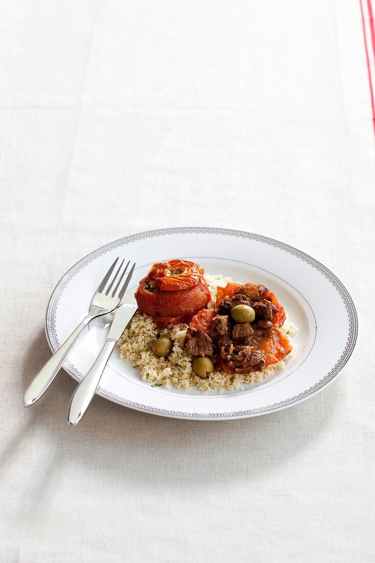 Tomatoes stuffed with beef on a bed of rice