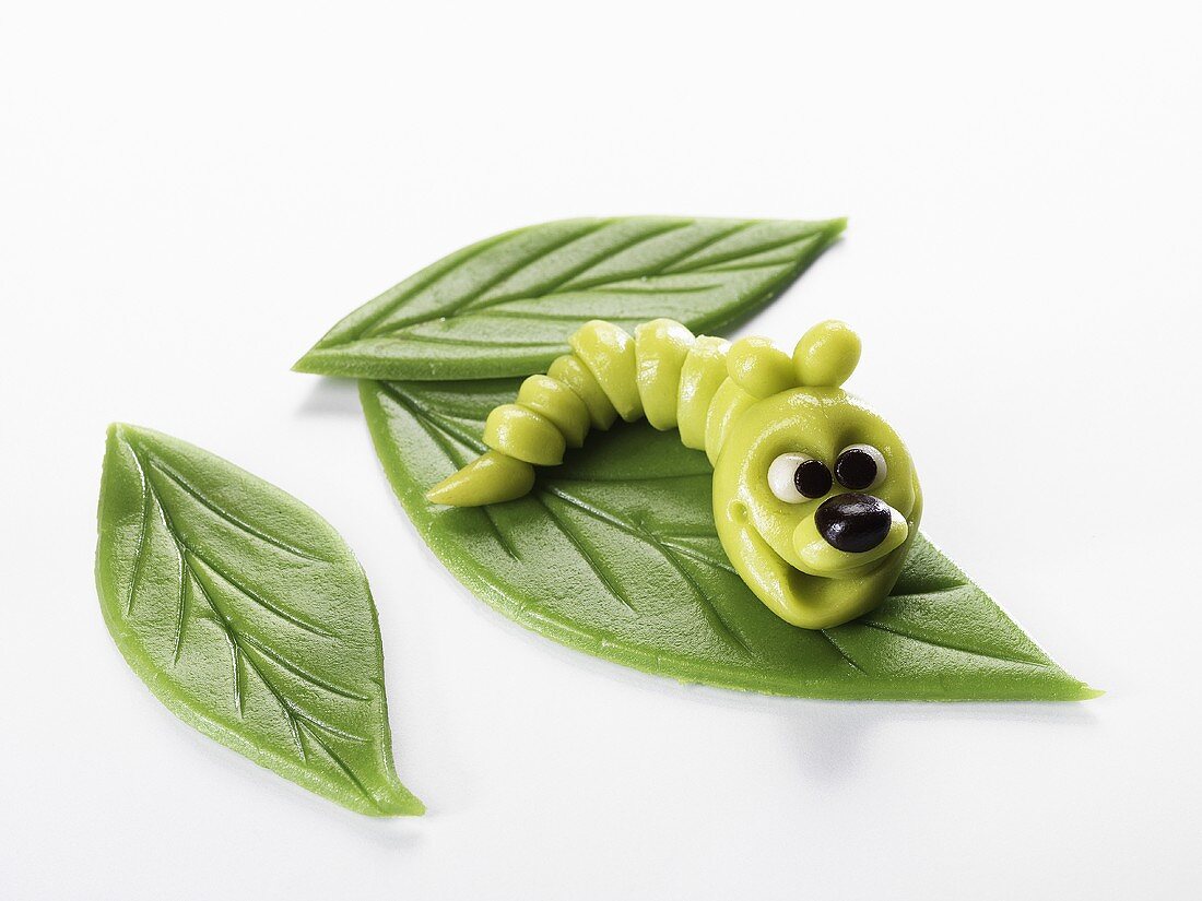 A marzipan caterpiller on marzipan leaves