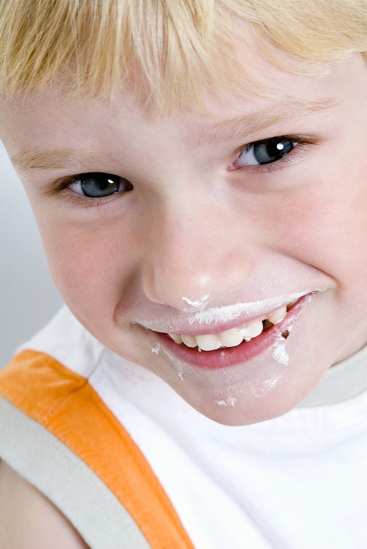 Blond boy after eating a chocolate-covered marshmallow wafer