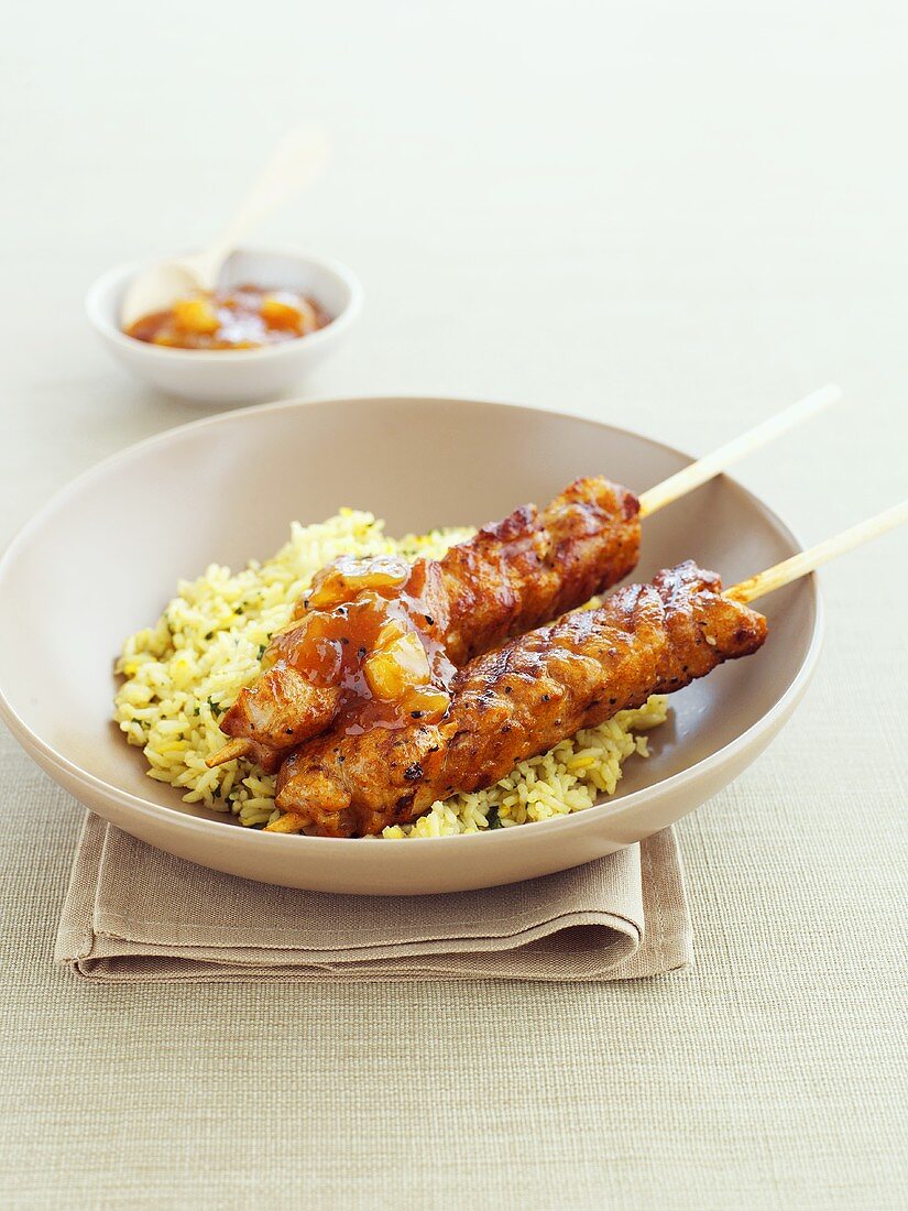 Marinated chicken skewers on saffron rice