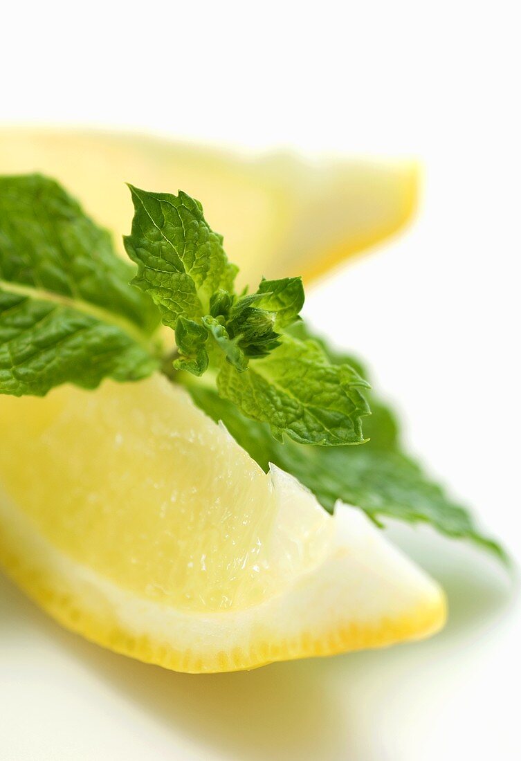 Two lemon wedges with mint