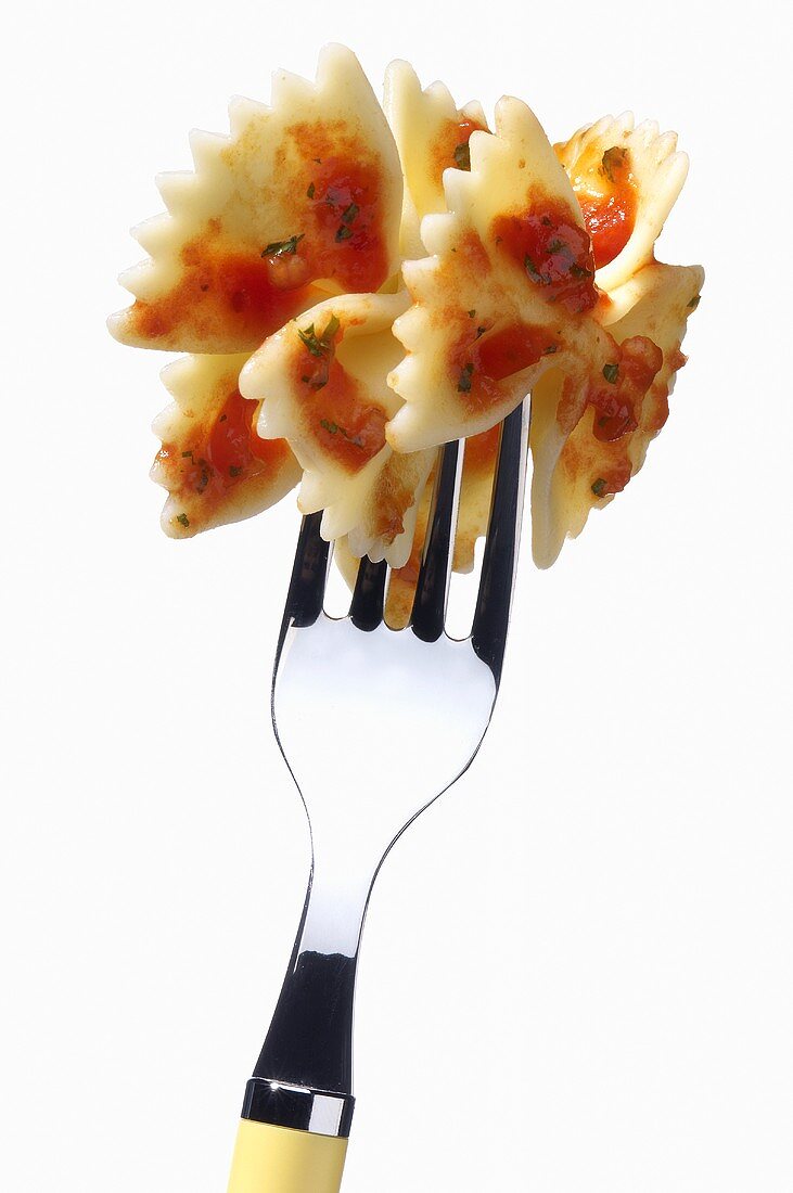 Farfalle with tomato sauce speared on a fork