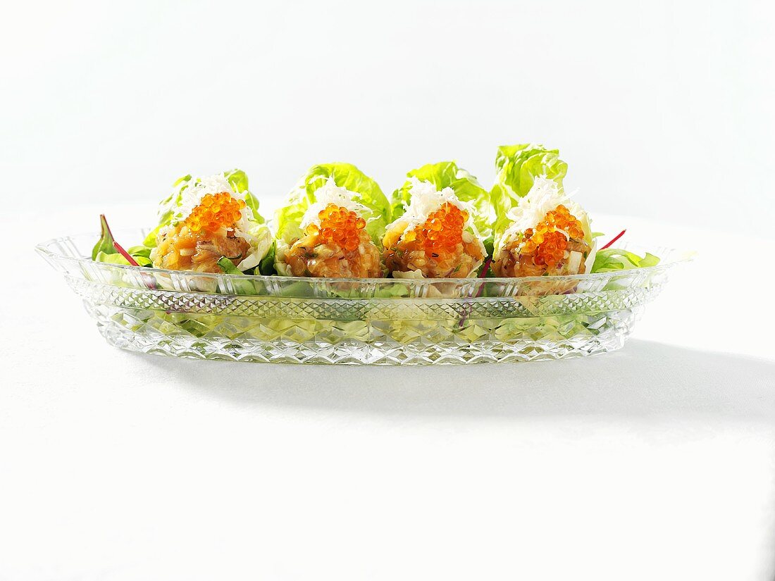 Salmon tartare with trout caviar in lettuce leaves