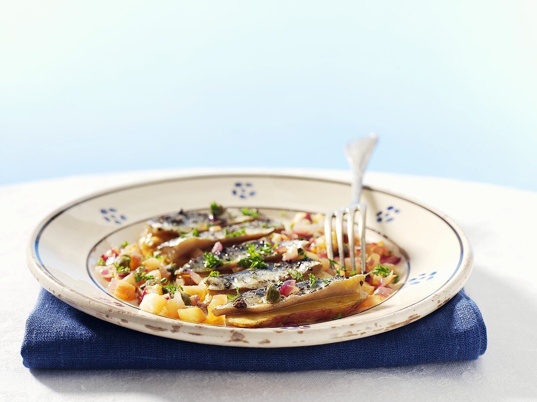 Marinated herring fillets with apple and capers