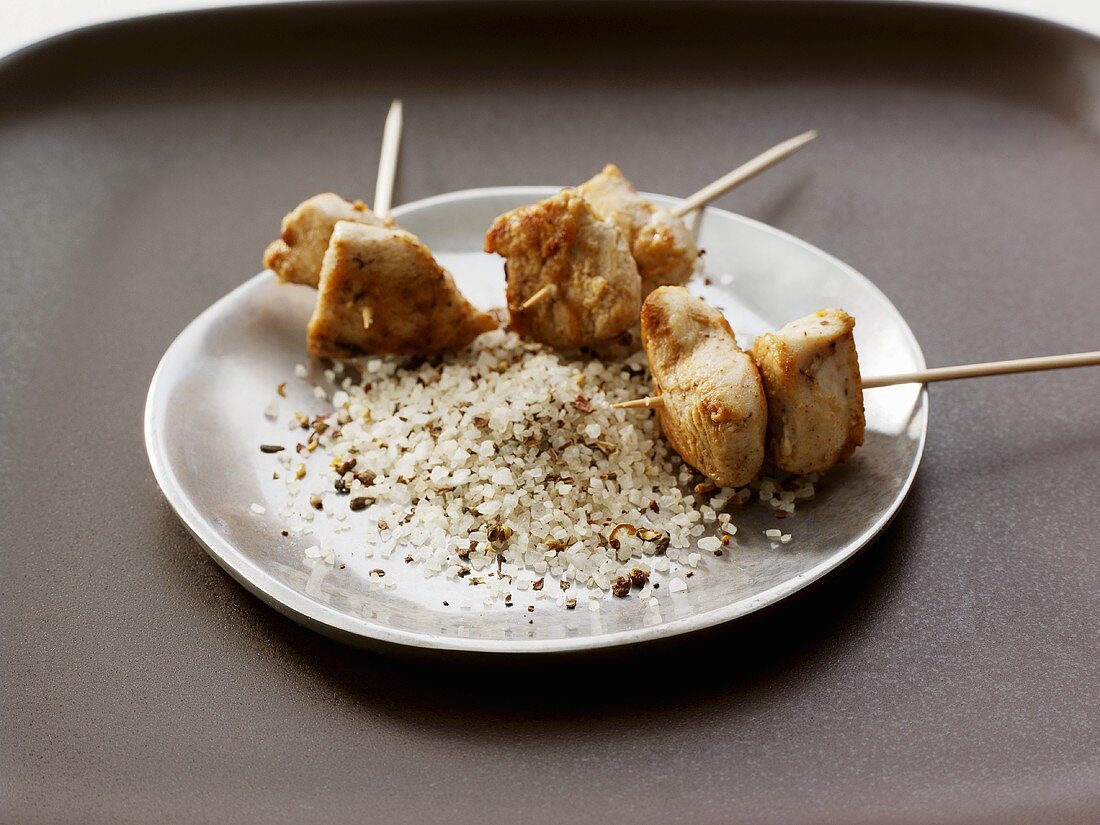 Chicken pieces on skewers with seasoned salt