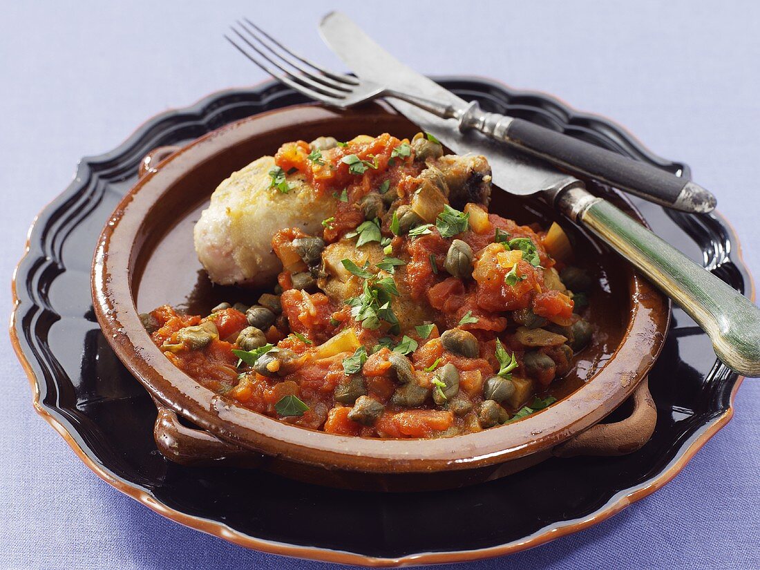 Chicken breast with tomato sauce, capers and green olives