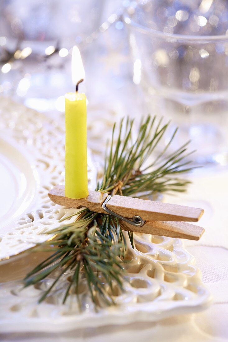 Christmas decoration: burning candle on clothes peg