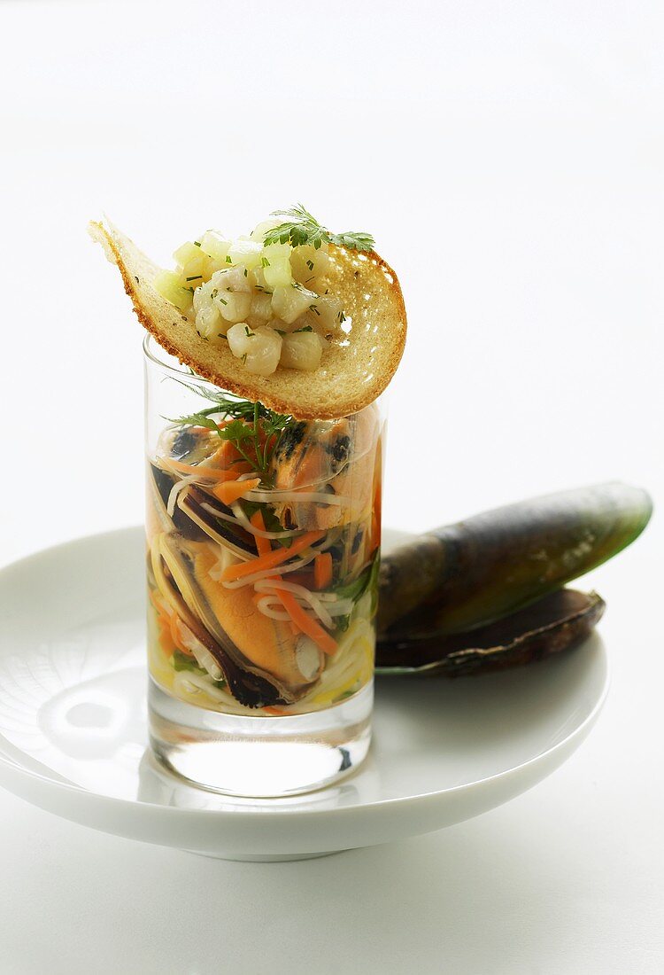 Green shell mussel stock with trout and cucumber tartare