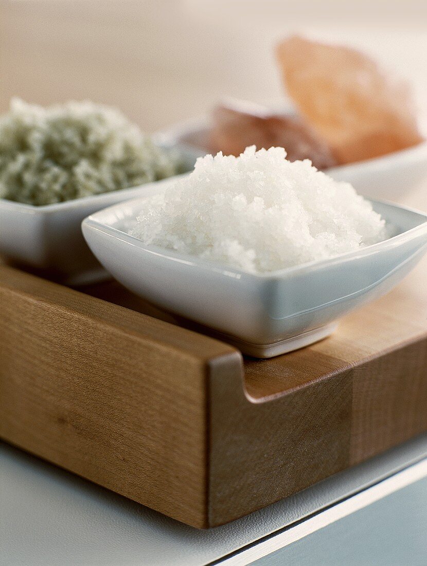 Three different types of salt in small bowls