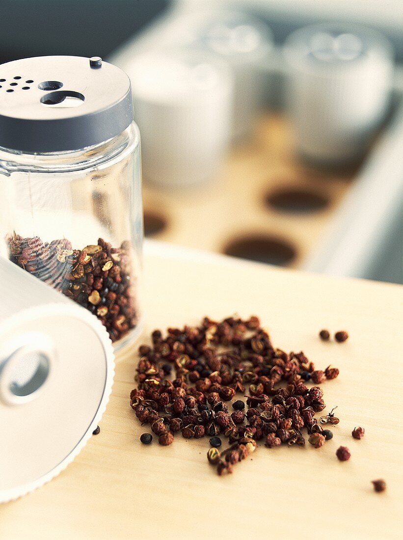 Peppercorns in jar and in a heap