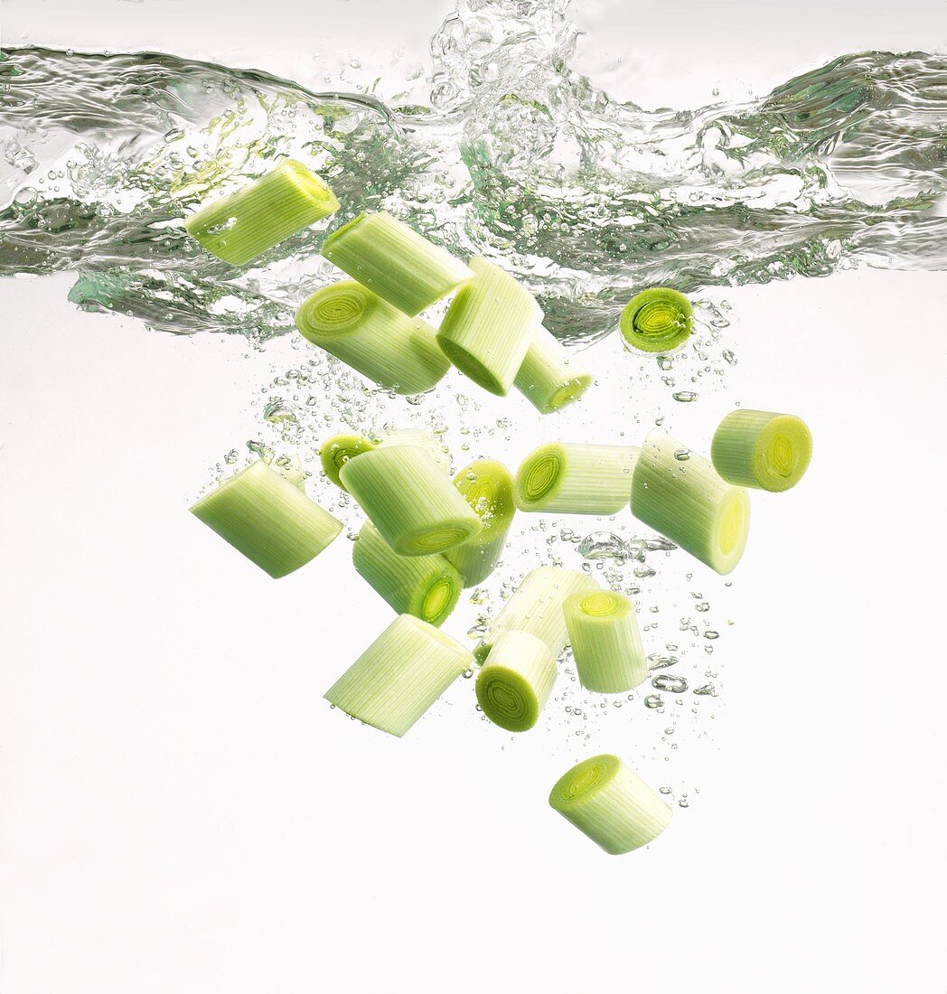 Freshly sliced leeks falling into water