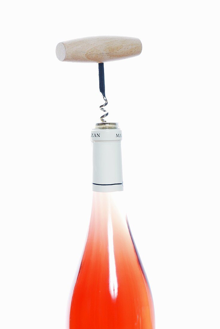 Corkscrew in a bottle of rosé wine