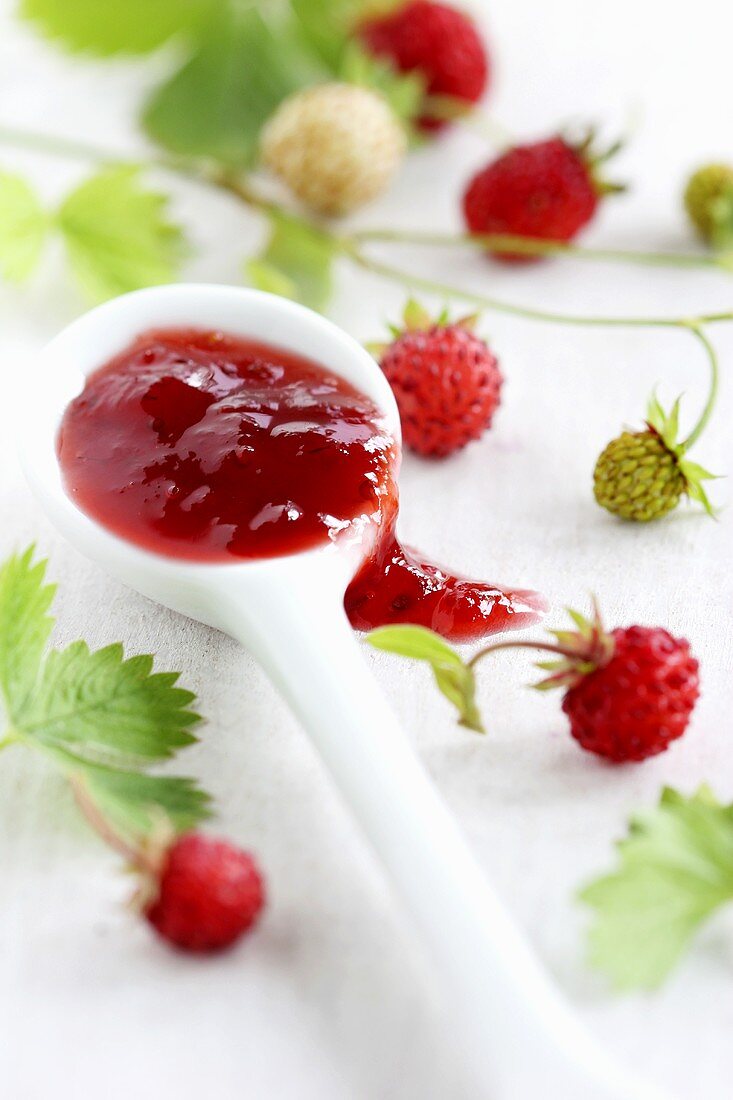 Wild strawberry jam on a spoon