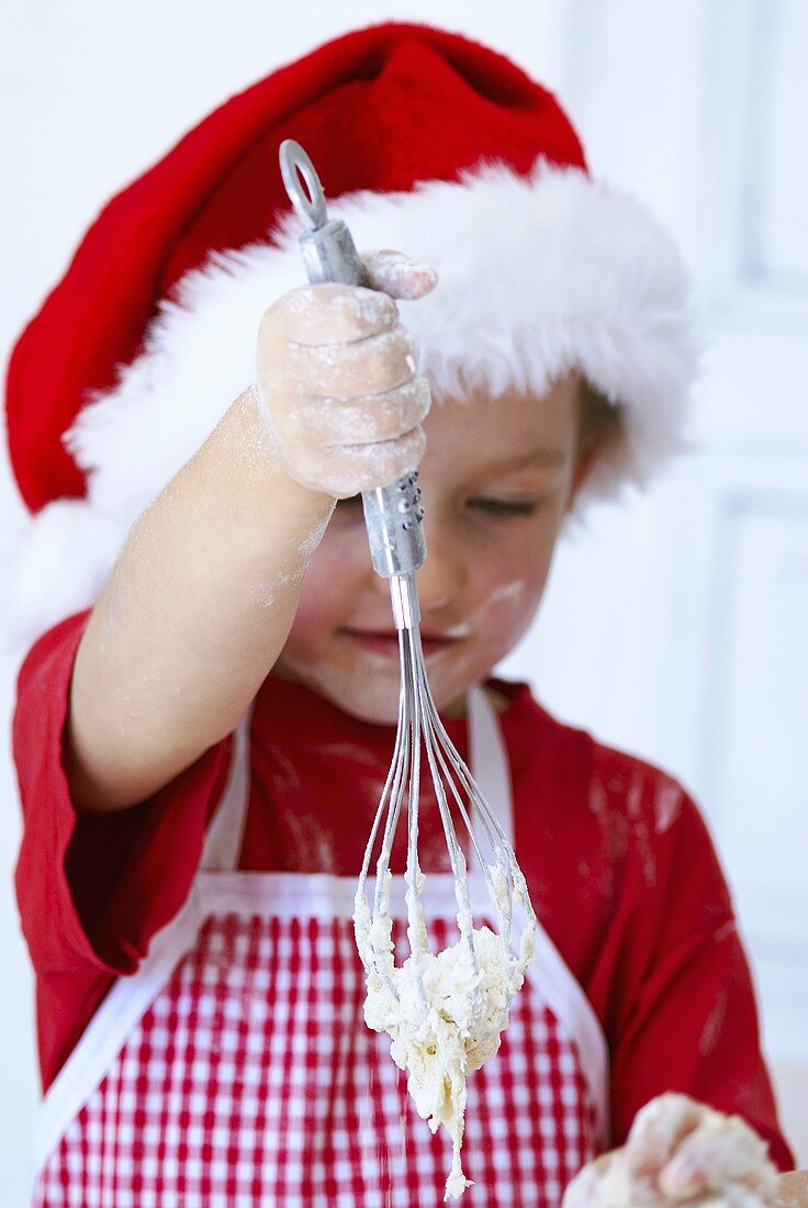 Girl mixing dough with a whisk